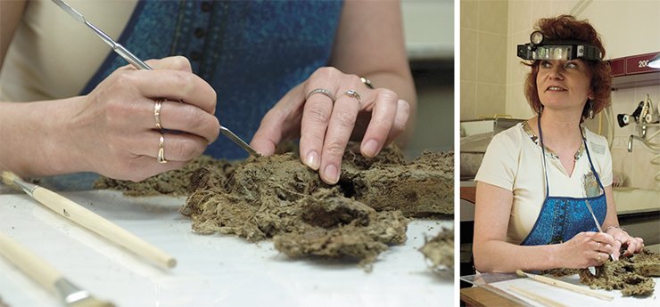M. V. Moroz, a fine art restorer with the Museum Studies Department of the Institute of Archaeology and Ethnography SB RAS, is engaged in near work: she is removing clay particles from fragments of the cloth