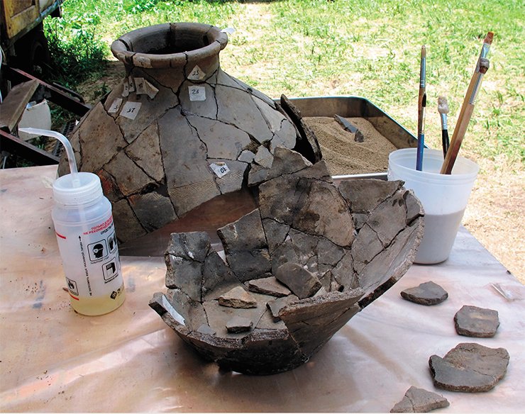 The reconstruction of this small ceramic pot, found in the grave broken, began right in the field. The flat-bottomed and narrow-necked jug, made on the wheel, has one round hole near the bottom. There are two hypotheses about the purpose of these pots, quite a few of which have been found in the Xiongnu graves. The first and the most widely-spread is that the vessels were used to keep grain, and the hole was a vent. The second, which appears more trustworthy, is that drinks (probably, milk beverages) were brewed in them. In this case, the hole was meant to pour off the clarified end product  