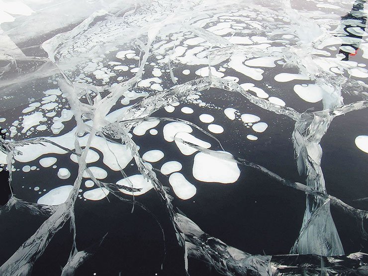 In winter, the methane bubbles released from the bottom sources freeze into ice. If a large volume of gas accumulates in the ice, it leads to the so-called 'proparinas' ranging from half a meter to several hundred meters in diameter. The ice in these areas is dangerously thin, or there is no ice at all. Photo by N. Granin