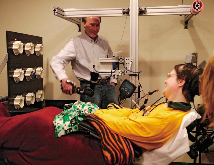 Спустя две недели после вживления электродов Джэн Шерман научилась управлять рукой-роботом, которую она назвала Гектор. На фото – Шерман, а точнее – ее механическая рука, обменивается рукопожатием с заведующим лабораторией «MotorLab» Э. Шварцем. Фото из архива Медицинского центра Питтсбургского университета (UPMC)
