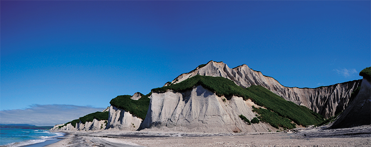 White Cliffs of Iturup are deposits of pumice tuffs, a product of a giant volcanic explosion or a series of explosions, which turn viscous magma into foam